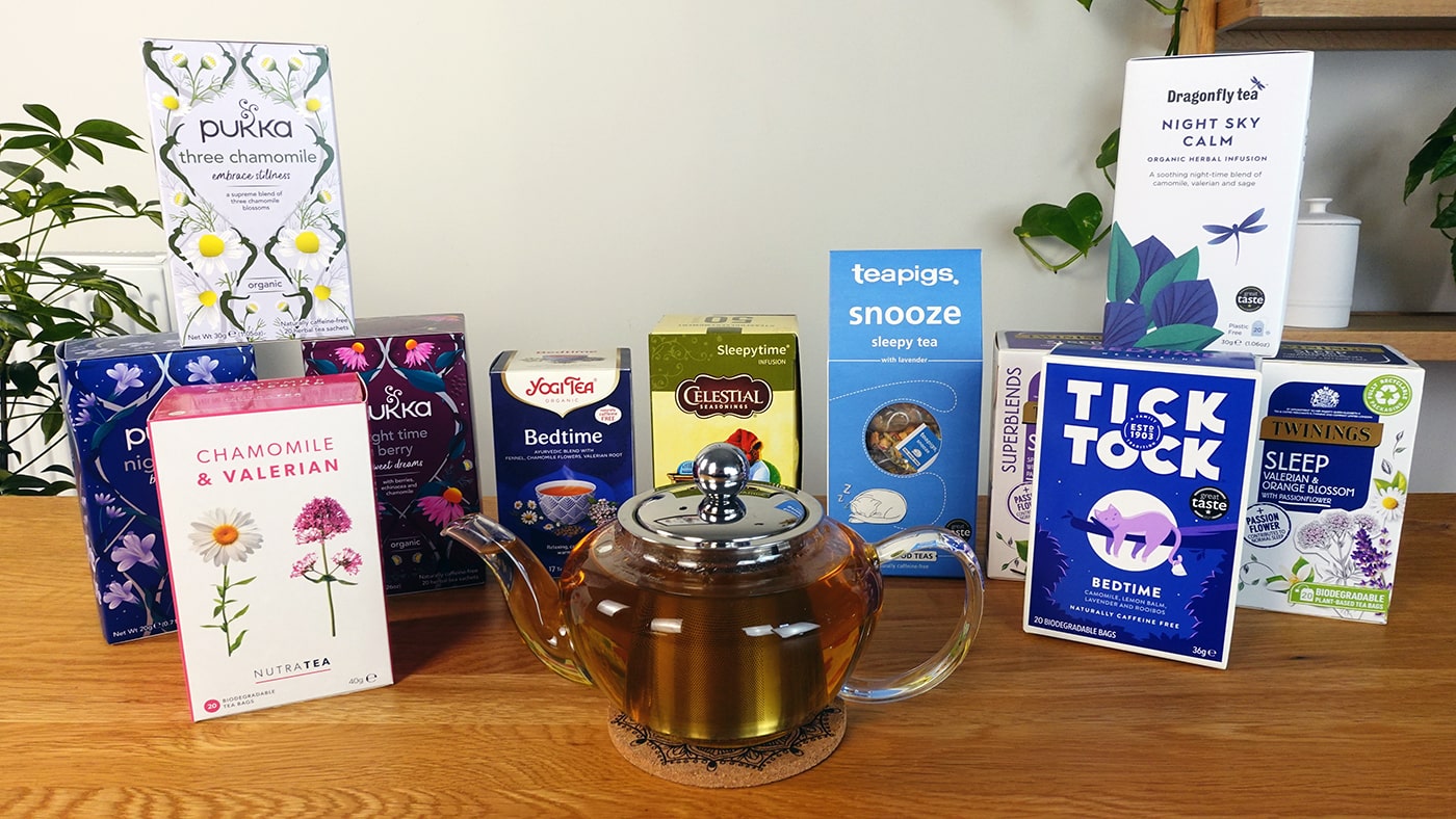 selection of herbal teas on a table with a teapot