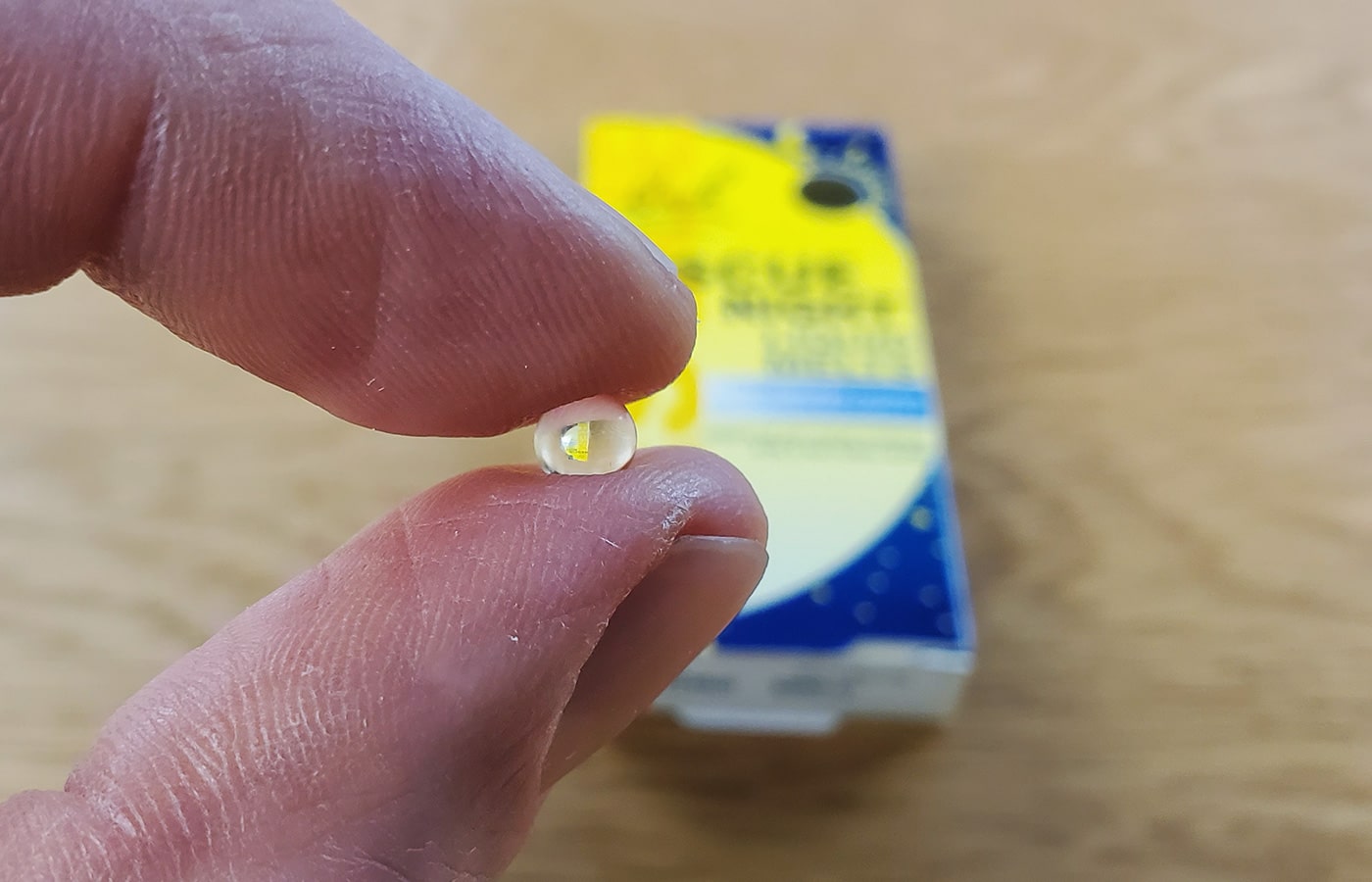 two fingers holding a Rescue Night capsule