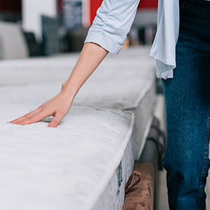 person choosing a mattress topper