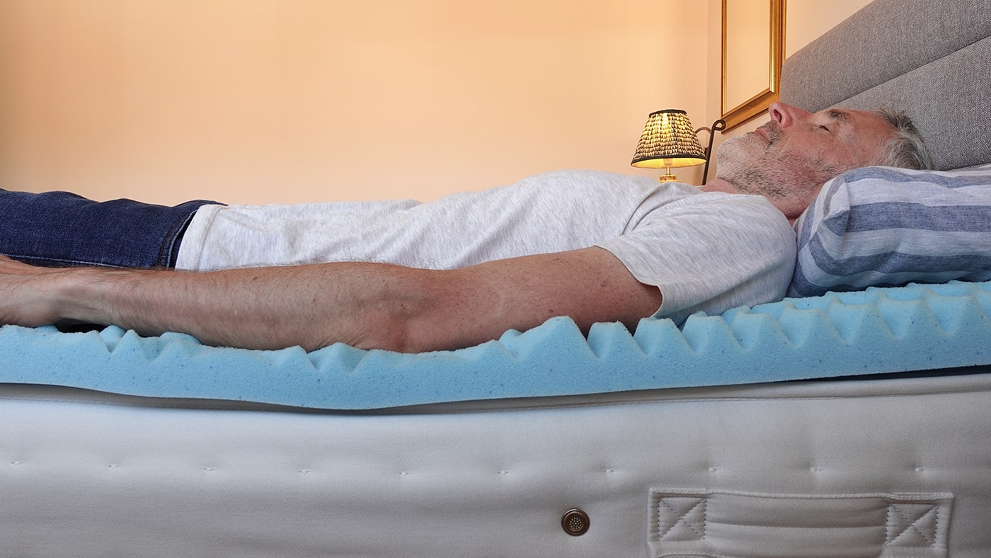 man lying on lucid mattress topper