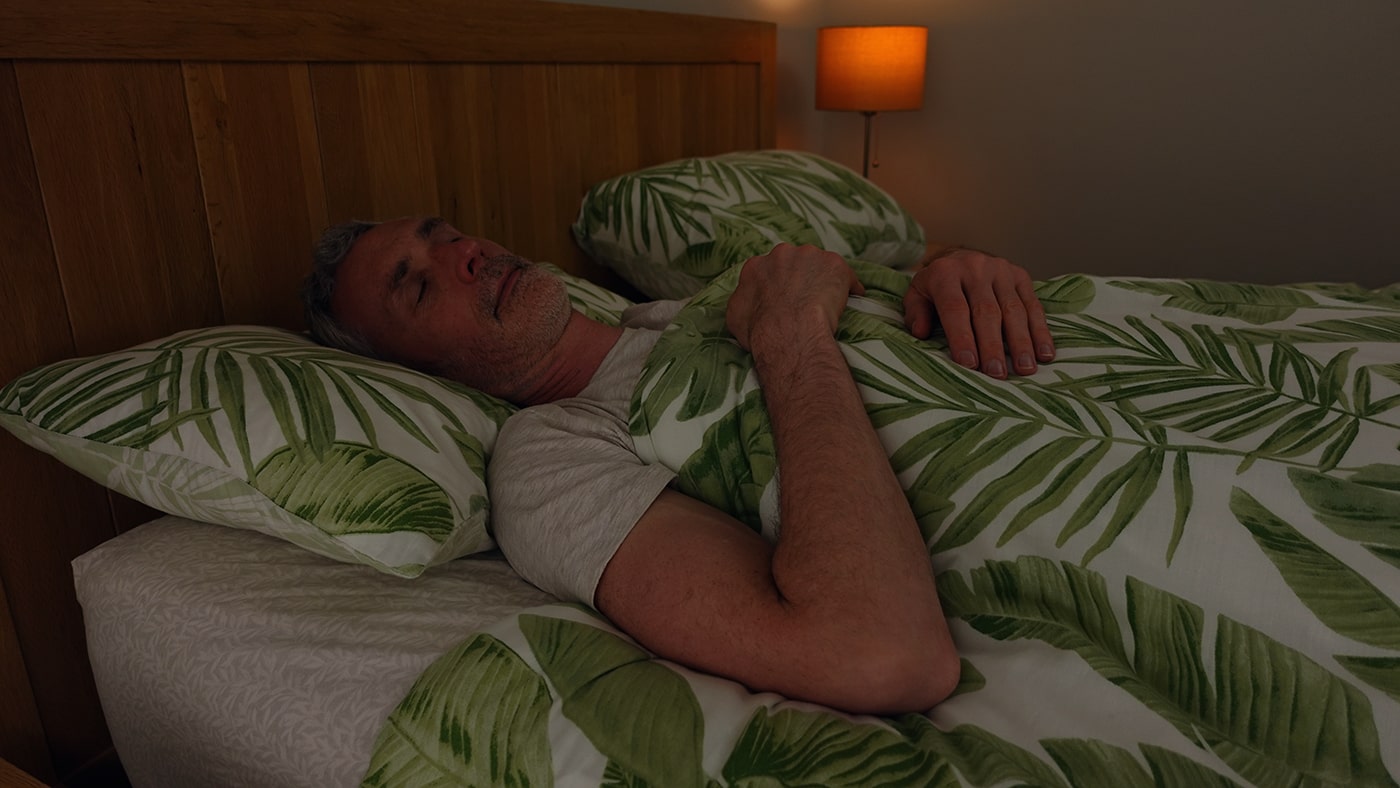 man sleeping in bed
