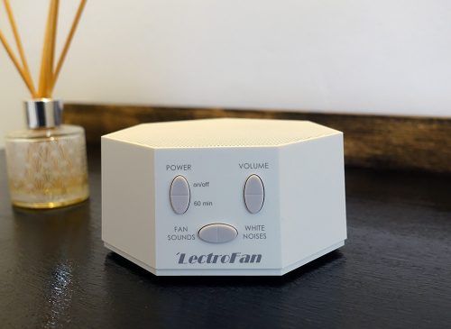 lectrofan white noise machine on a bedroom table