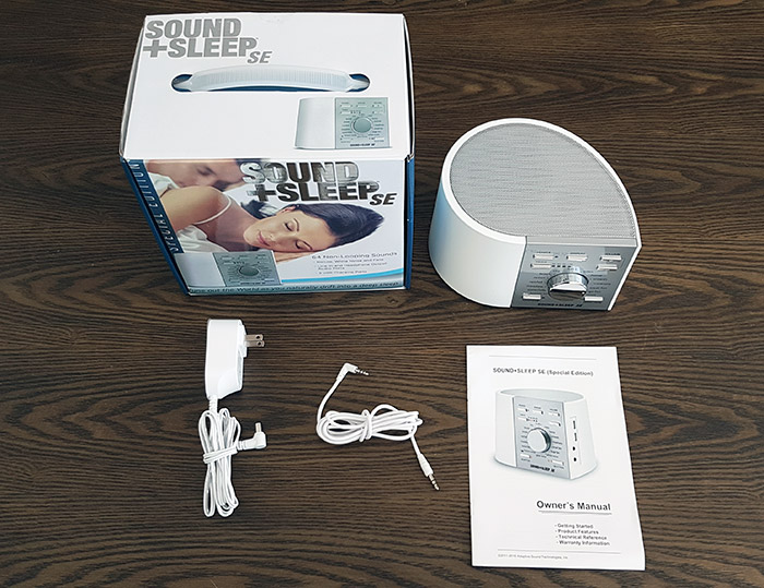 photo of the sound+sleep with the box, manual, charing cable and audio in cable