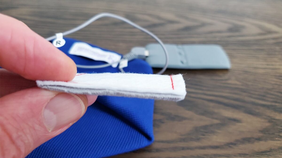 photo of a hand holding one of the sleepphones internal padded speakers