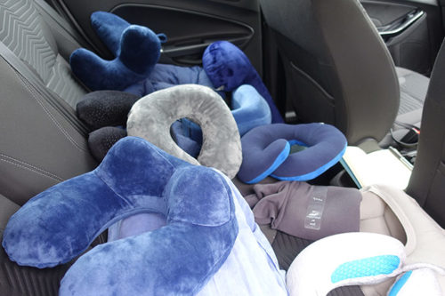 lots of travel pillows in a car