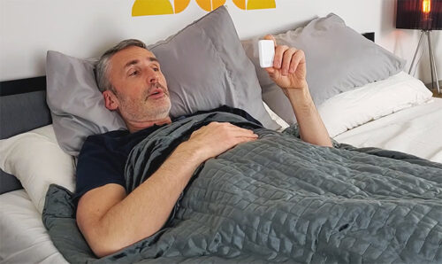 man testing breathable weighted blankets