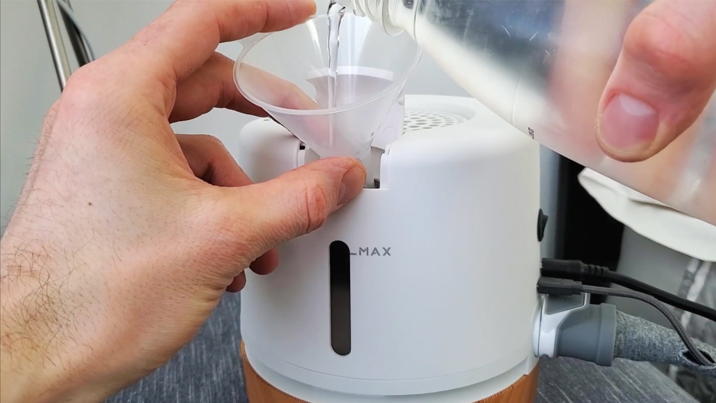 photo showing pouring water into the moona device when installing it