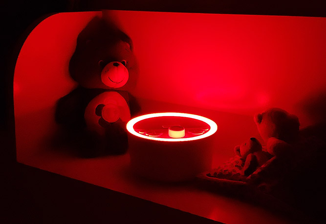 renpho sound machine night light on red in a bedroom at night