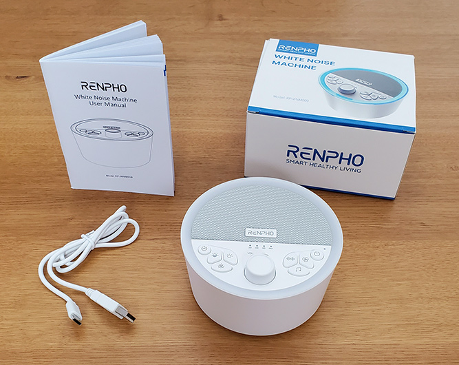 photo of the renpho white noise machine, the charging cable, box and user manual.