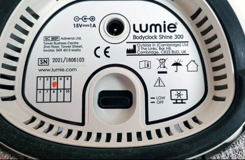 photo of the underside of the bodyclock shine 300 showing warnings and power input