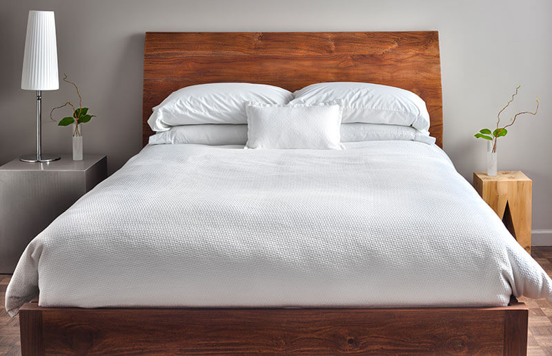photo of a bed in a modern looking bedroom