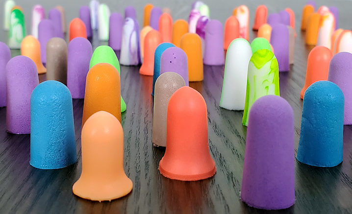 different styles of foam earplugs on a table