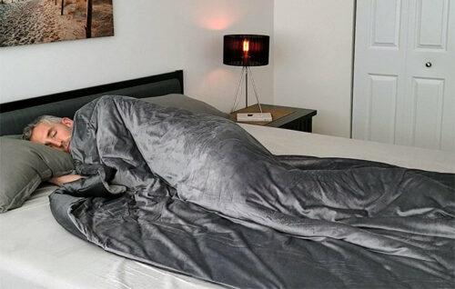 A man sleeping under the Luxome weighted blanket