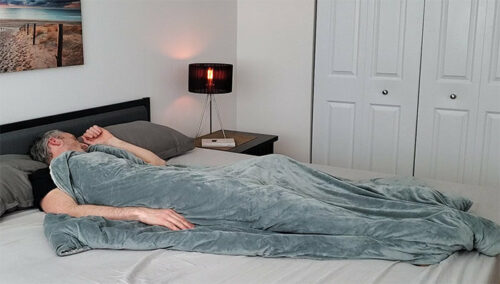 A man sleeping under the Quility weighted blanket