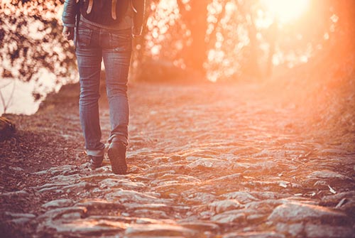 person walking at sunset