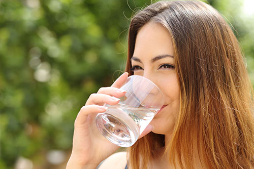 woman drinking a glass of water