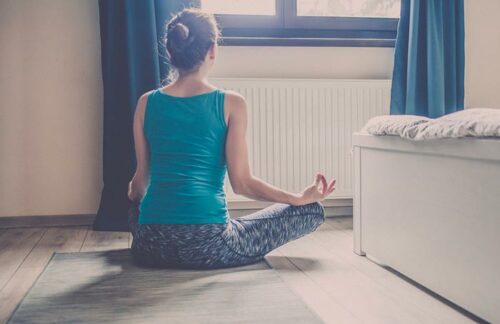 woman meditating in the bedroom