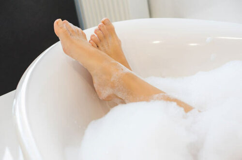 photo of two feet in a hot bath