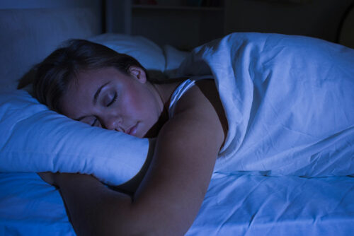 woman sleeping under a cover