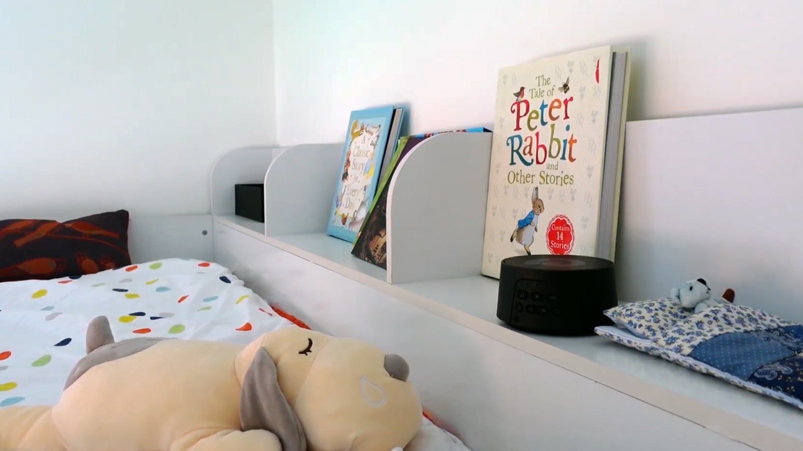 Dreamegg D3 Pro white noise machine on a shelf in a kid's room