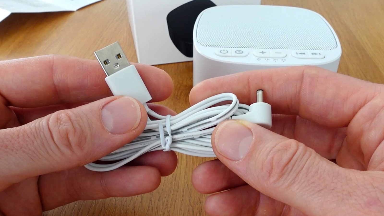 hands holding the Magicteam charging cable
