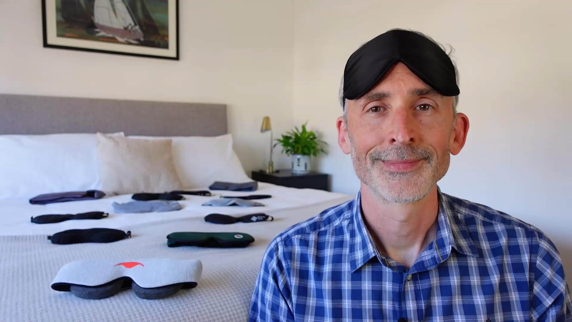 photo of Ethan Green in a bedroom with lots of sleep masks