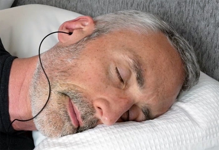 man in bed wearing the Maxrock Headphones