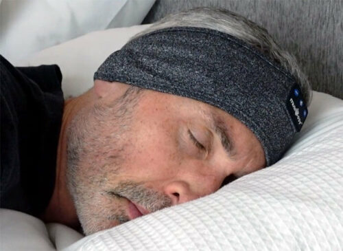photo of a man in bed using the Musicozy headphones