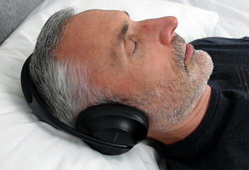 man sleeping with Bose noise cancelling headphones 700.jpg