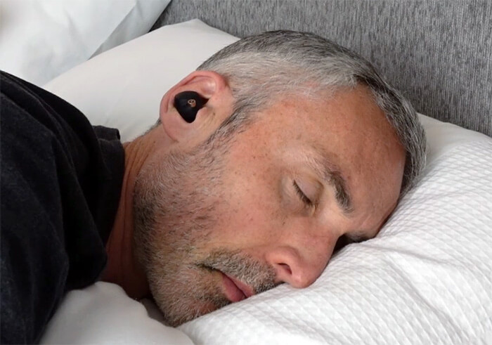 photo of a man sleeping and wearing the Sony WF-1000XM4 headphones