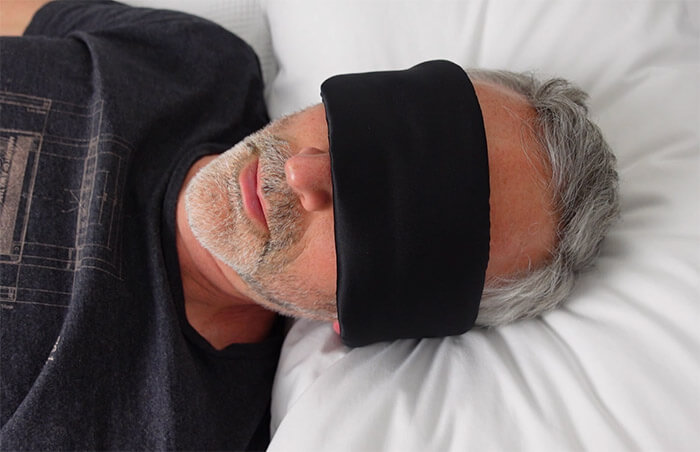 man wearing alaska bear silk sleep mask