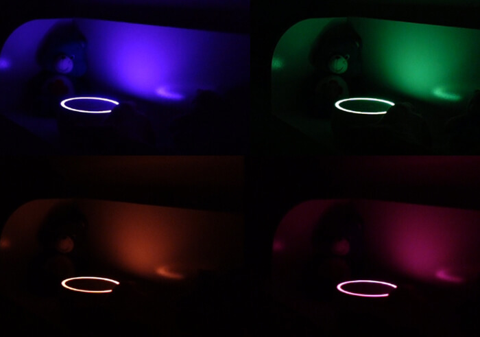 photo of a range of Yogasleep Dreamcenter nightlight settings: blue, green, orange and pink