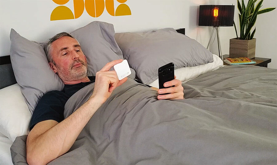 man testing a duvet temperature