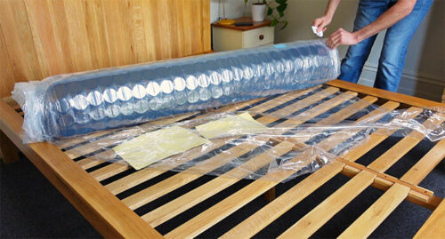 Inofia mattress being unrolled out of the plastic wrapper