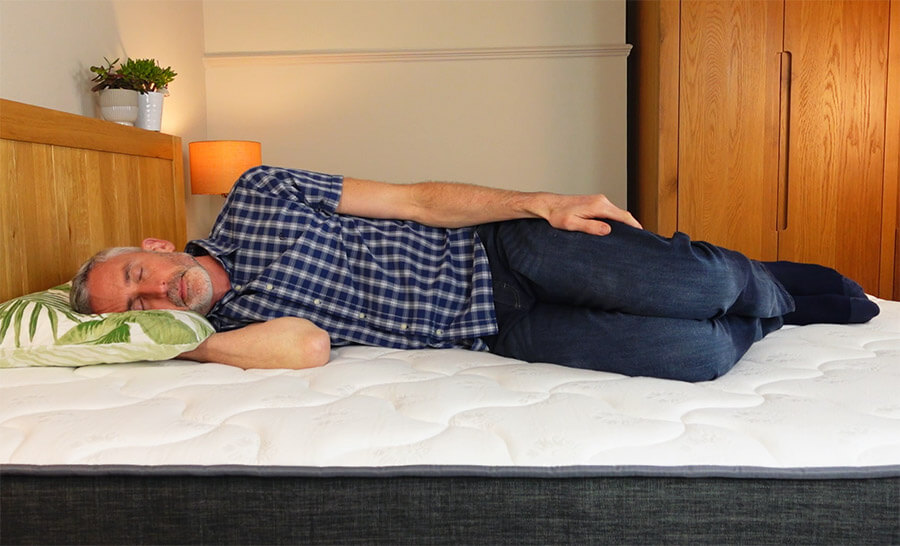 man lying on his side on the Inofia hybrid mattress