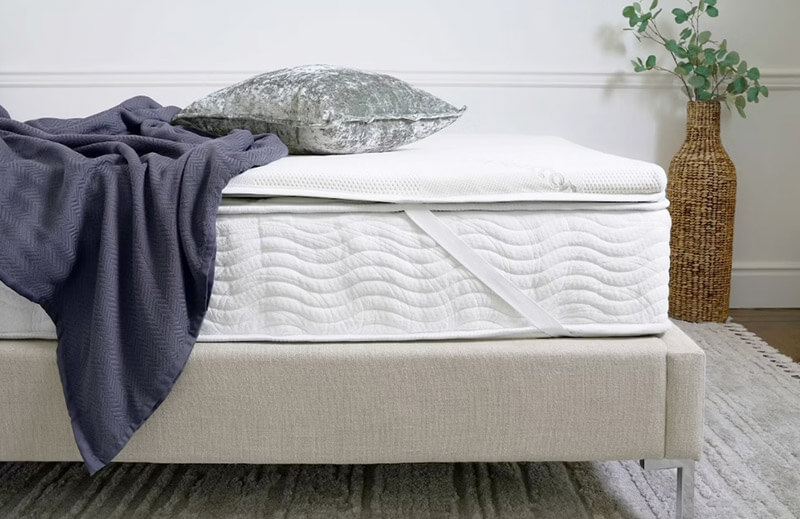 mattress topper on a mattress in a bedroom
