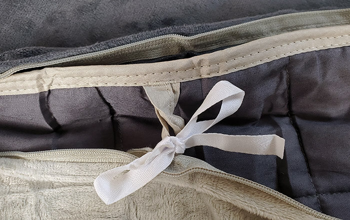 photo of one of the loops and ties used to attach the Cosi Home cover to the weighted blanket