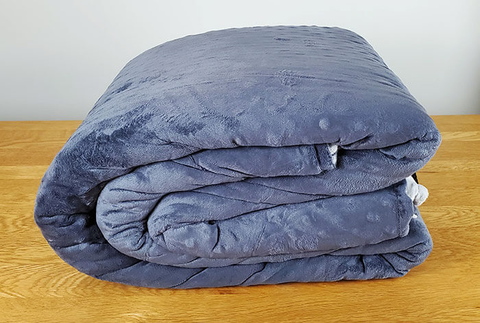 photo of the Cosi Home weighted blanket folded up on a table