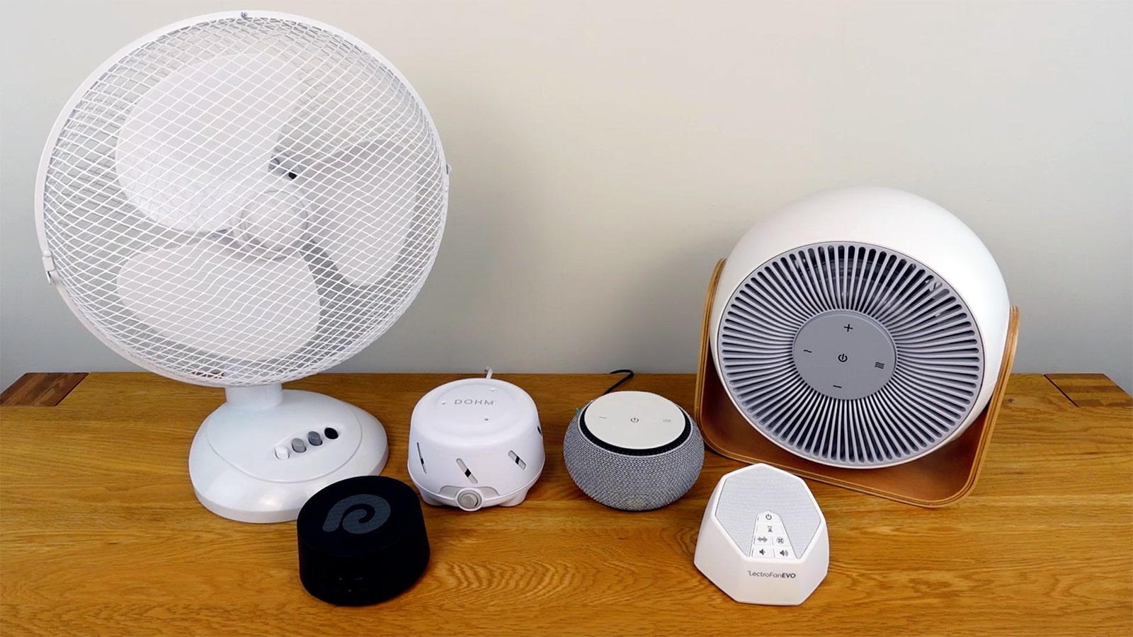 SNOOZ Breez on a table with a desk fan, lectrofan evo, snooz, dreamegg d3 pro, and dohm Uno