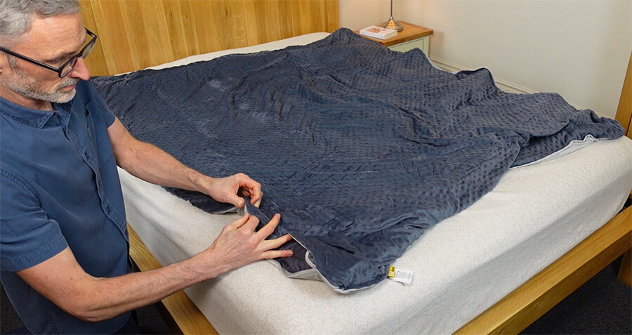 man zipping up weighted blanket duvet cover