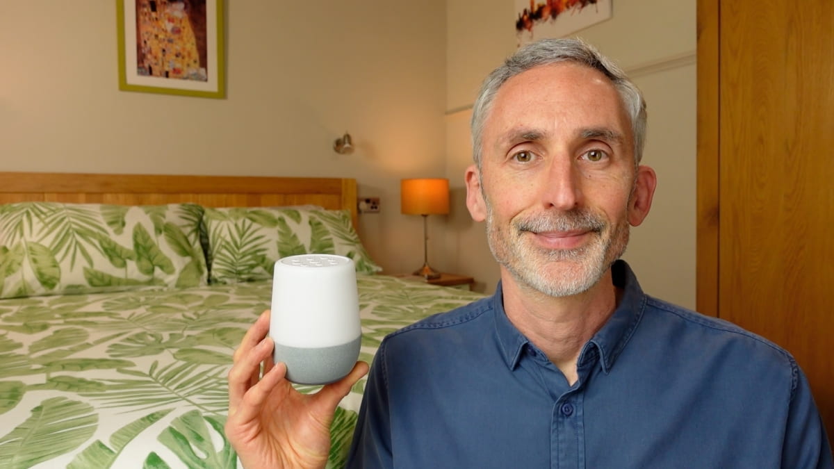 man holding the Yogasleep Duet white noise machine