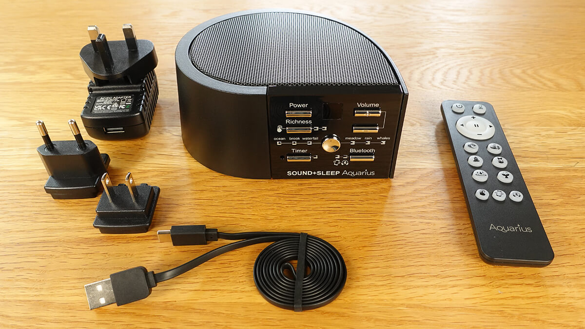Sound+Sleep Aquarius with remote control, charging cable, and power adaptors