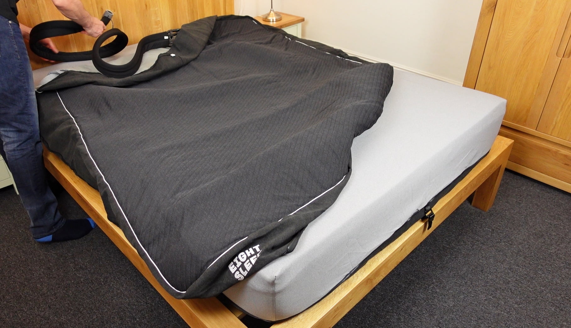 man setting up the Eight Sleep Pod 3 Cover active grid