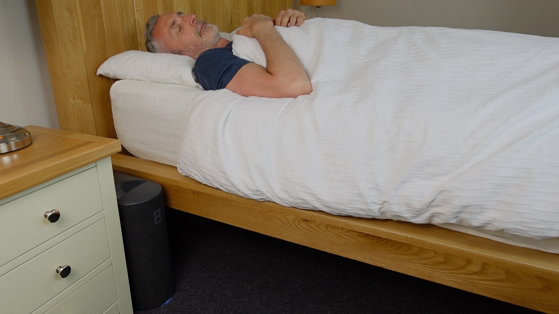 man sleeping in bed with the Eight Sleep Pod 3 cover operational