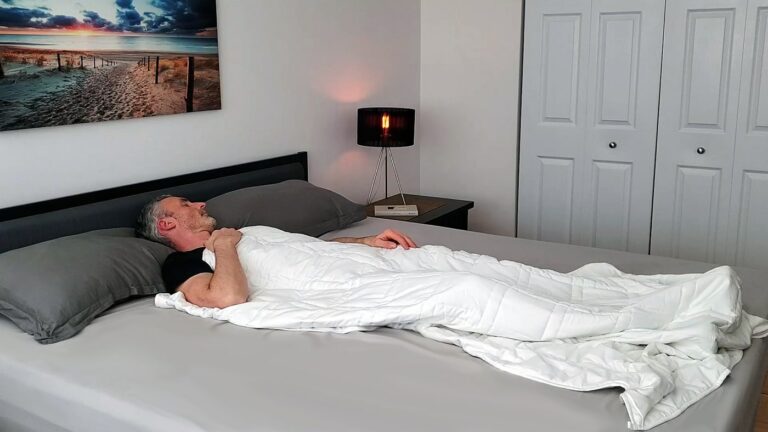 man sleeping under a weighted blanket