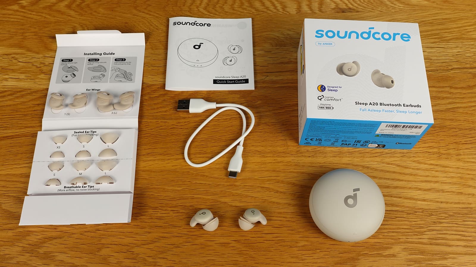 Soundcore Sleep A20earbuds, case, charging cable, extra wings and tips, user guide, and box.