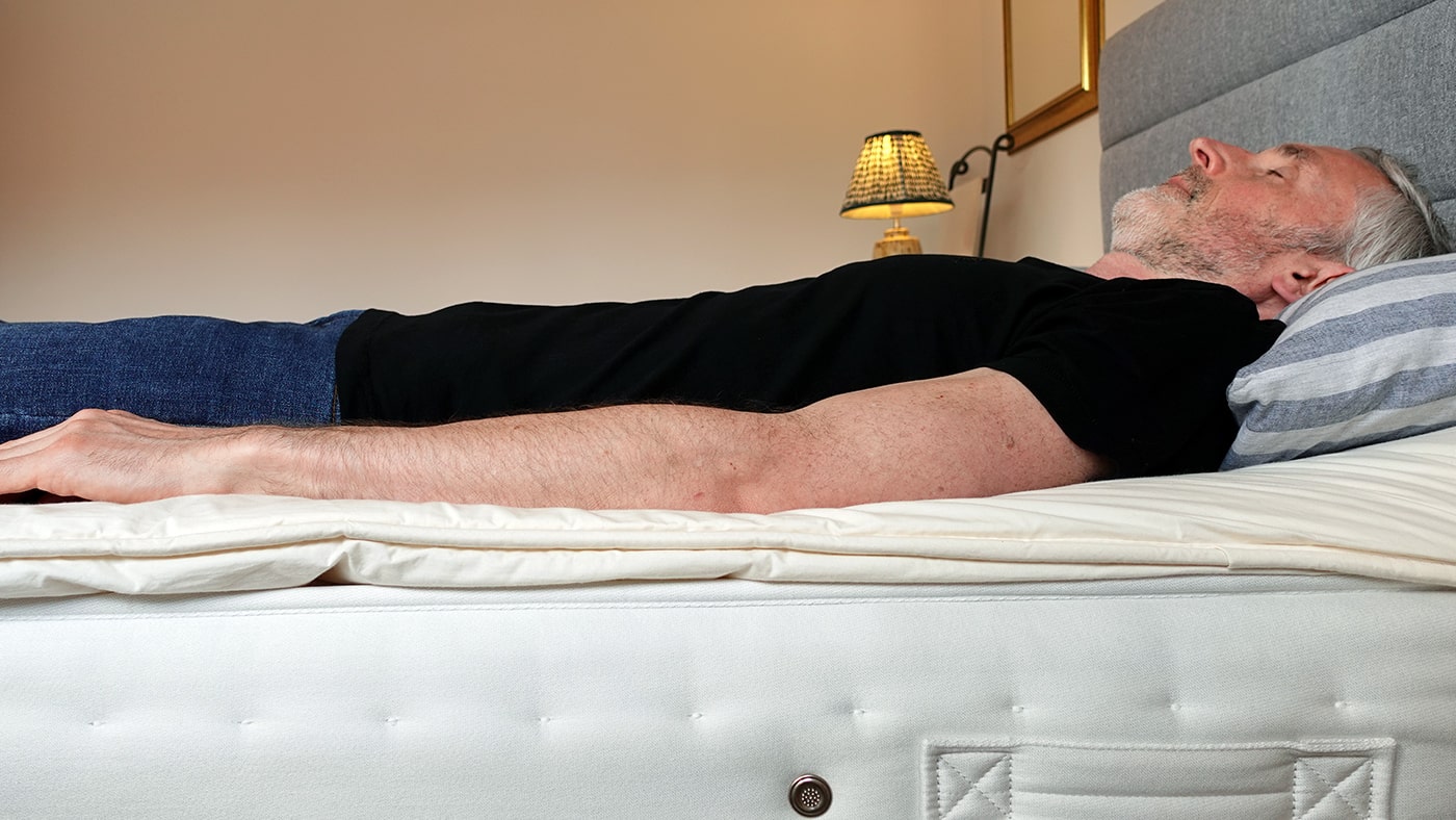 man lying on the Wool Room mattress topper