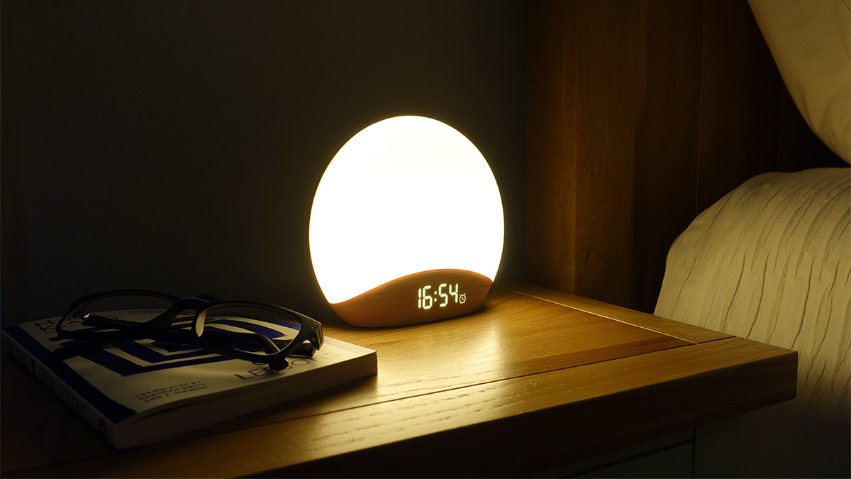 Reacher Sunrise Alarm Clock on a bedside table