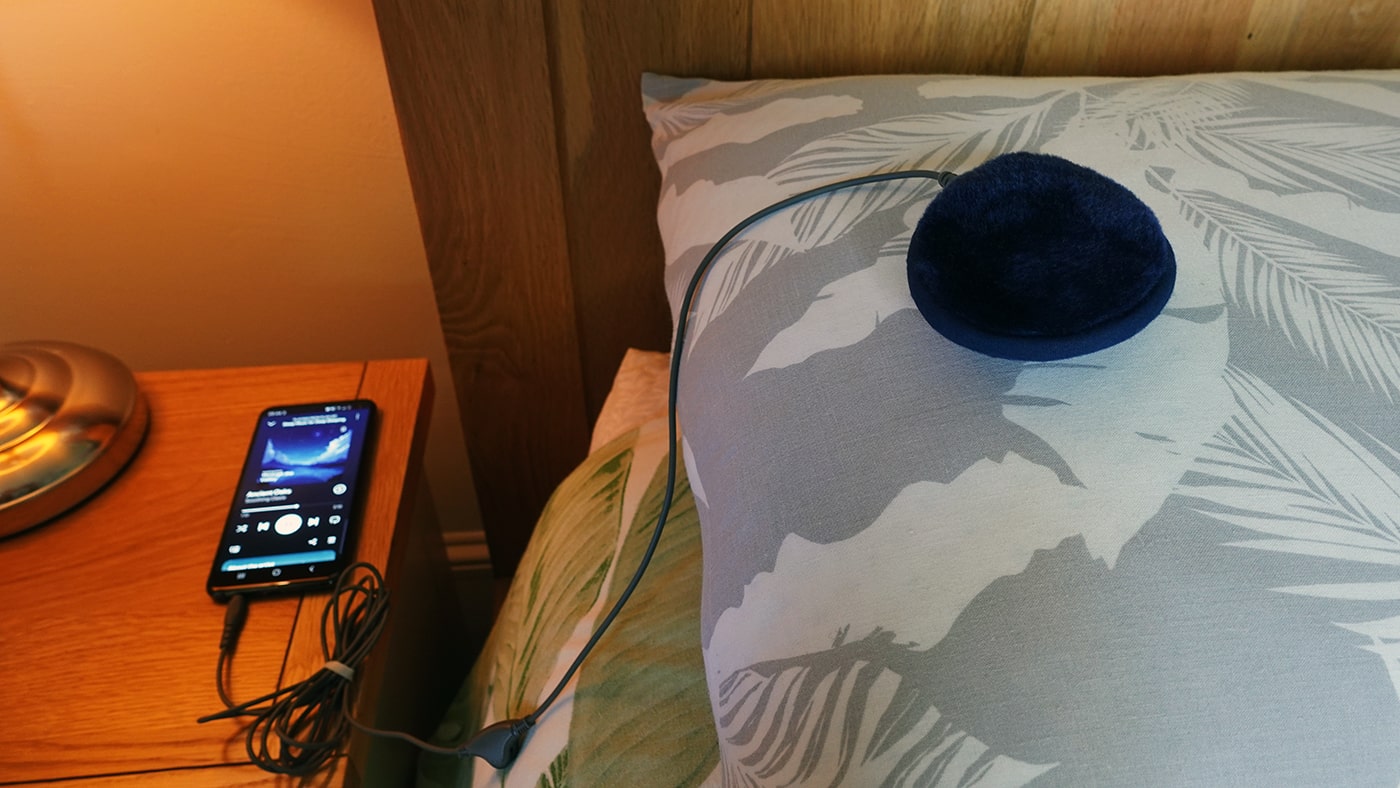 c crane soft speaker 2 set up on a pillow in a bedroom