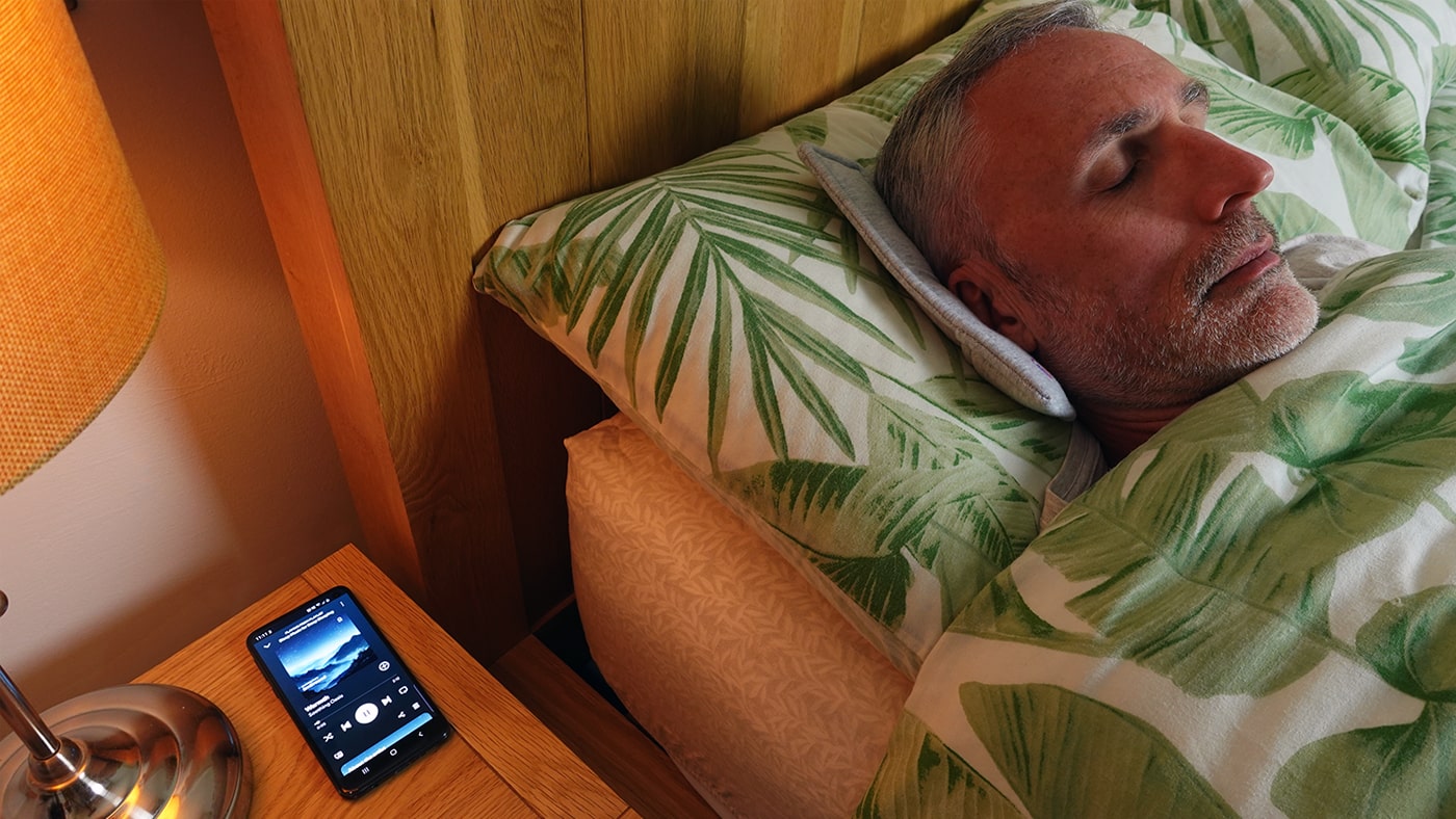 man using the Drowsie pillow speaker